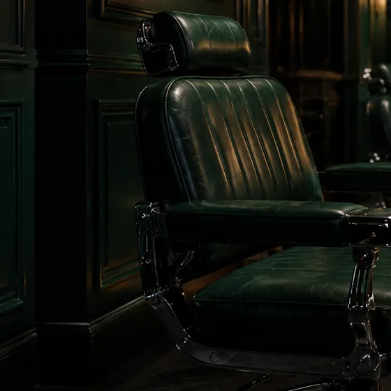 Green leather barber chair with chrome fittings